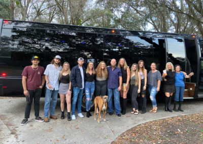 Friends going to concert in front of party bus
